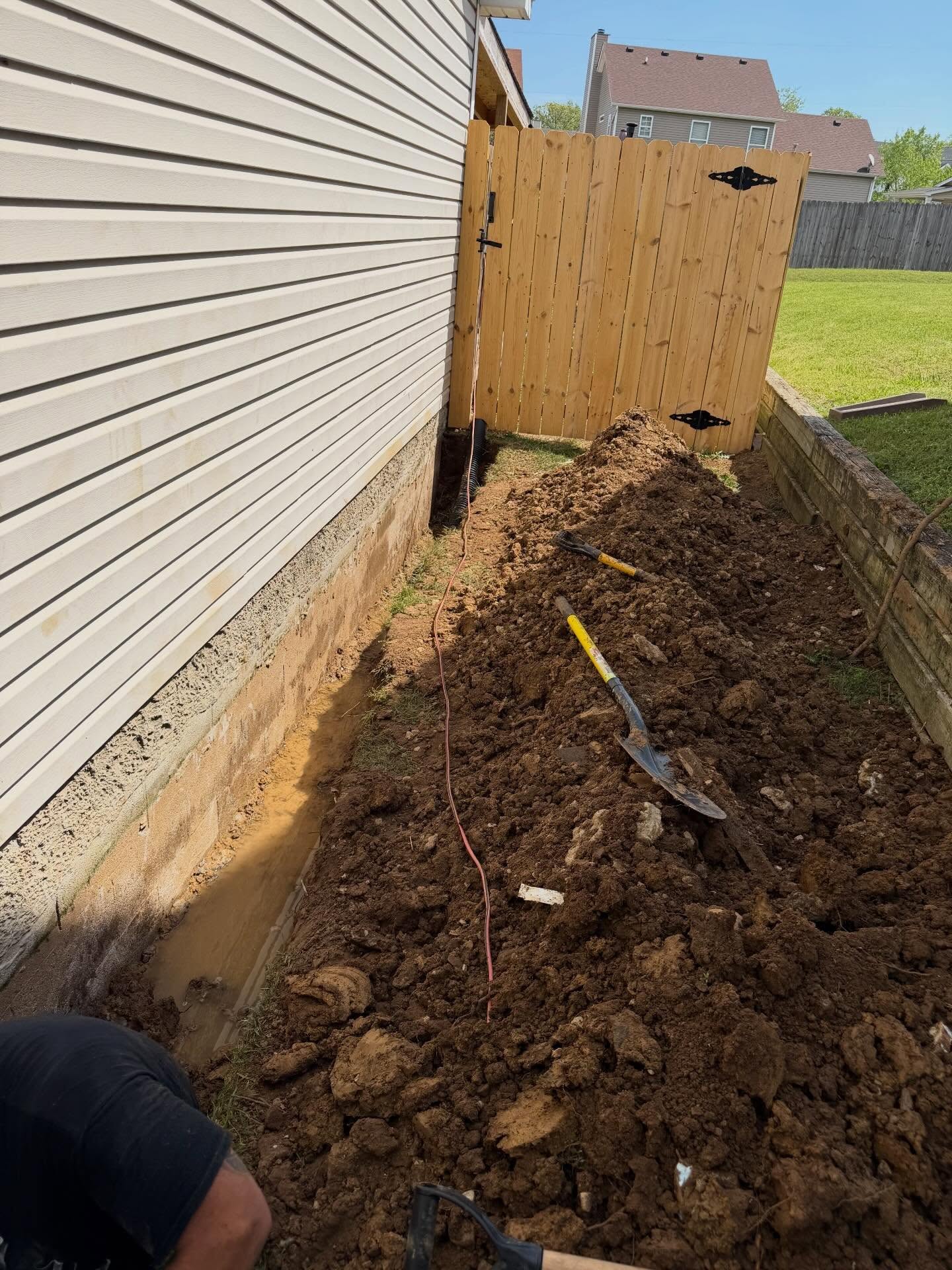 French drain installation beside a home foundation by Miller's Construction
